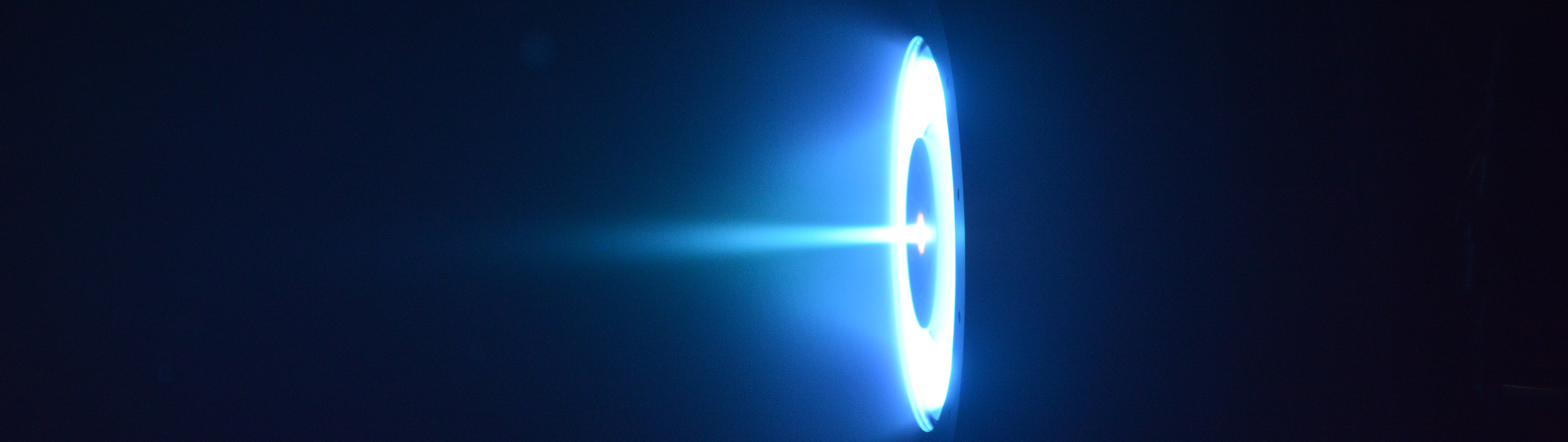 Hall thruster firing for the first time in a vacuum chamber at the Plasmadynamics and Electric Propulsion Laboratory at the University of Michigan.