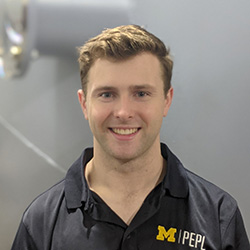 Headshot of Ph.D. student Will Hurley wearing a blue collared shirt with the University of Michigan PEPL logo.